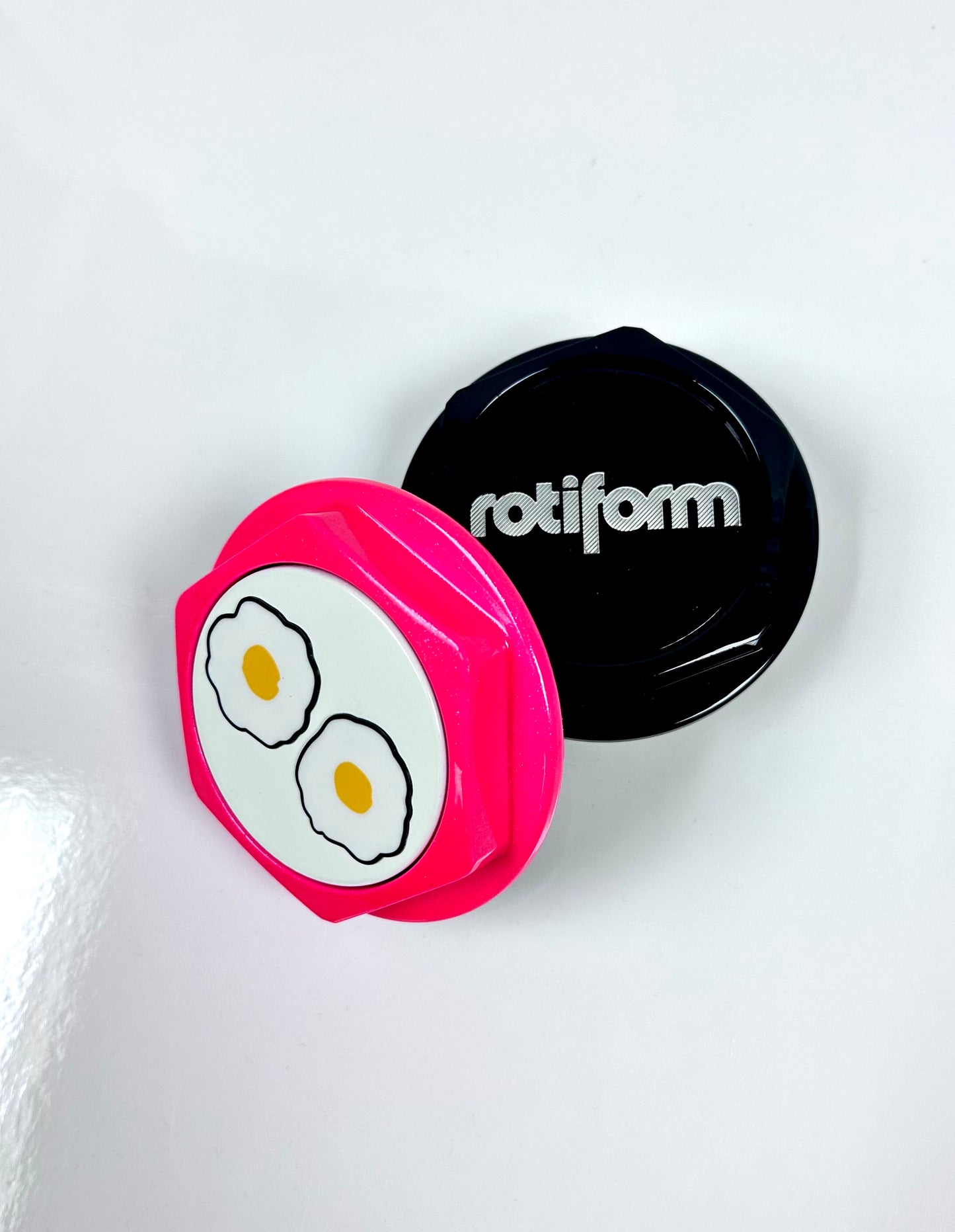Pink and black circular objects with 'rotiform' branding on a white background
