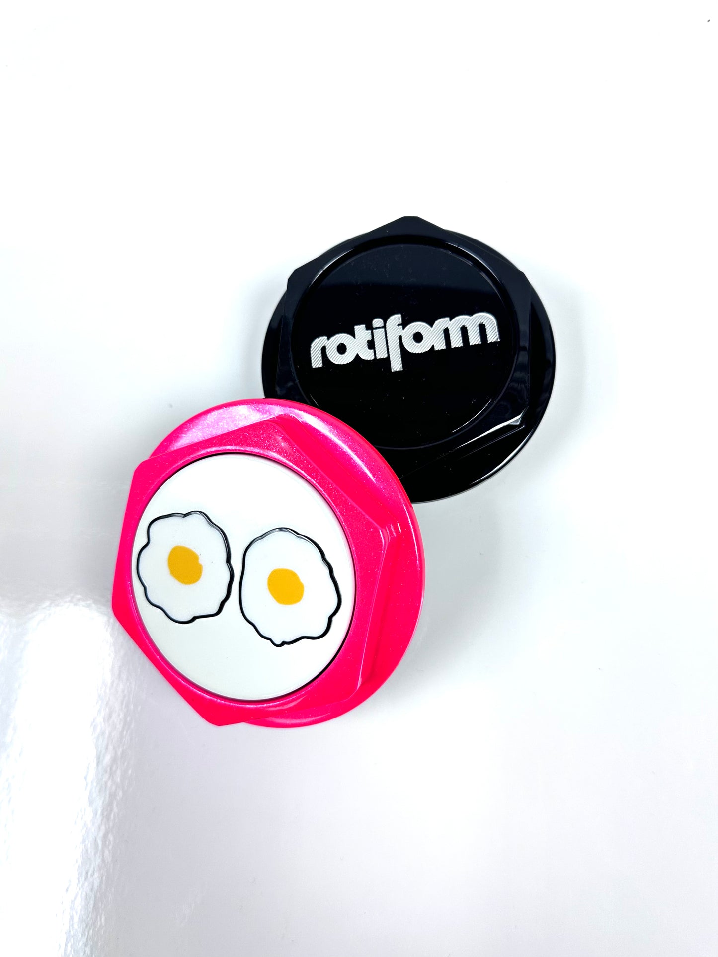 Pink container with cartoon eggs design and black lid featuring 'rotiform' brand on a white background