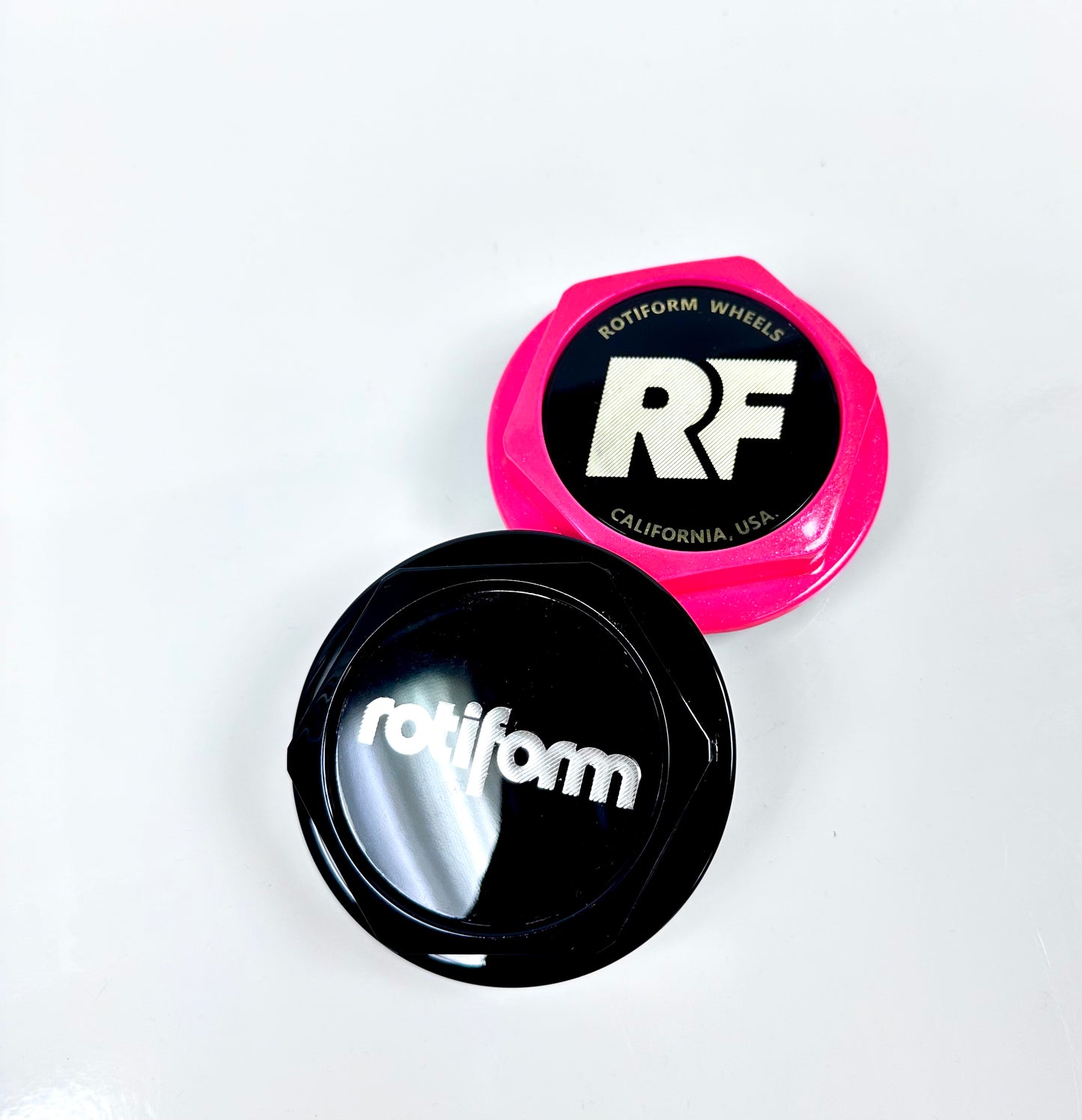 Two car wheel rim caps with 'rotiform' branding on a white background