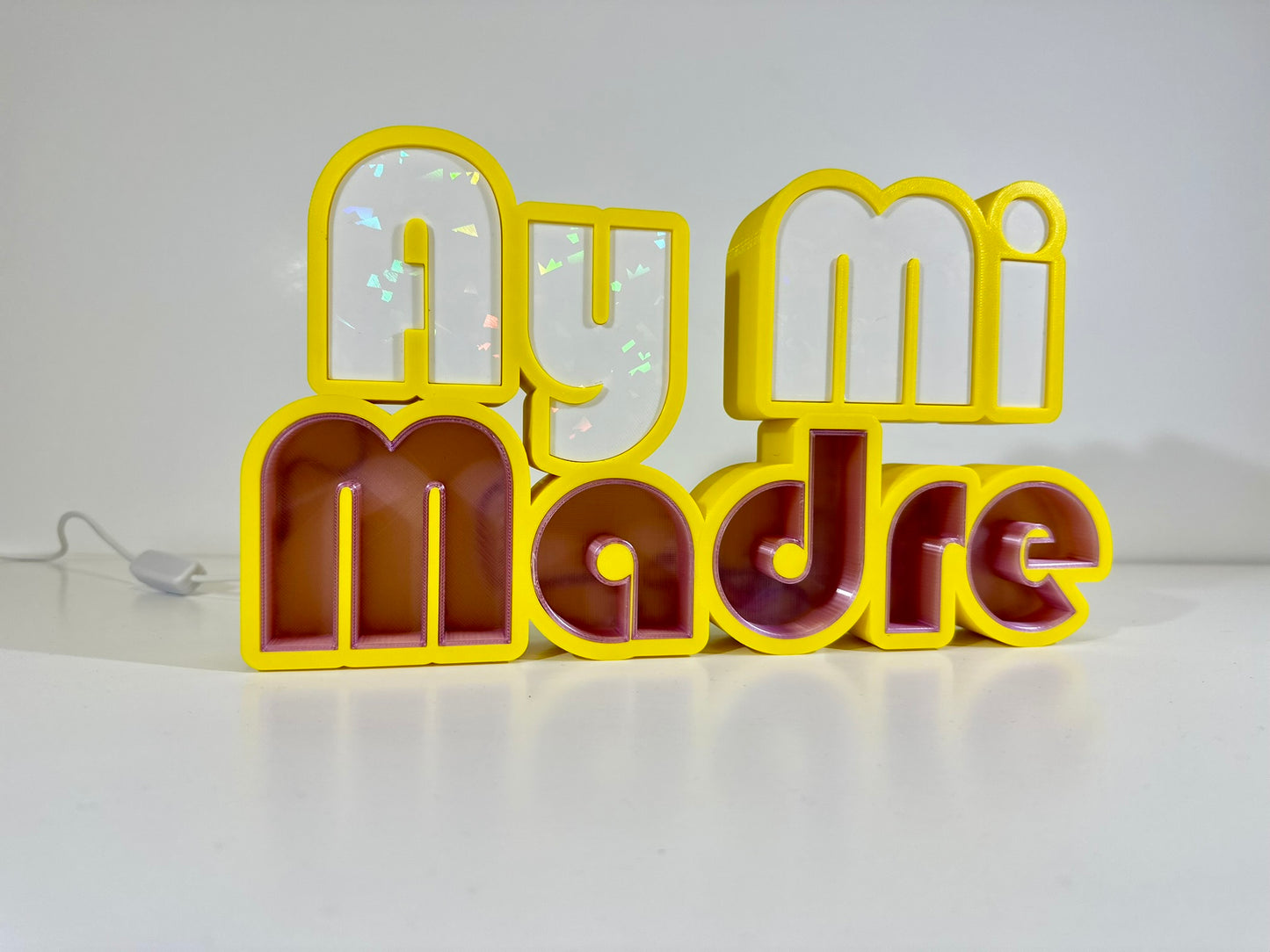 Front view of Ay Mi Madre LED Channel Letter Sign in yellow with red and white letters, displayed against a white background.