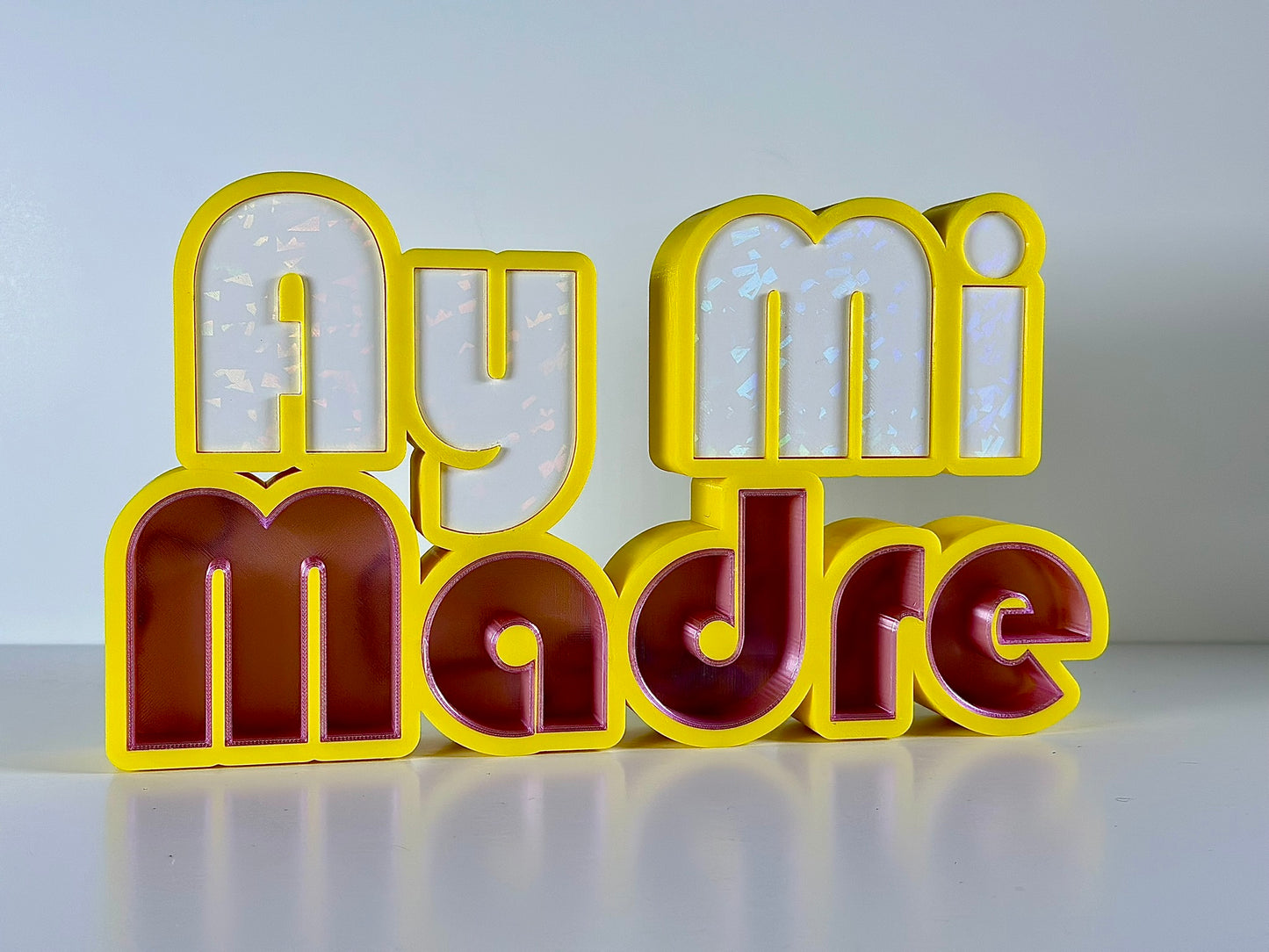 Front view of Ay Mi Madre LED Channel Letter Sign in yellow with red and white letters, showing the illuminated effect against a white background.