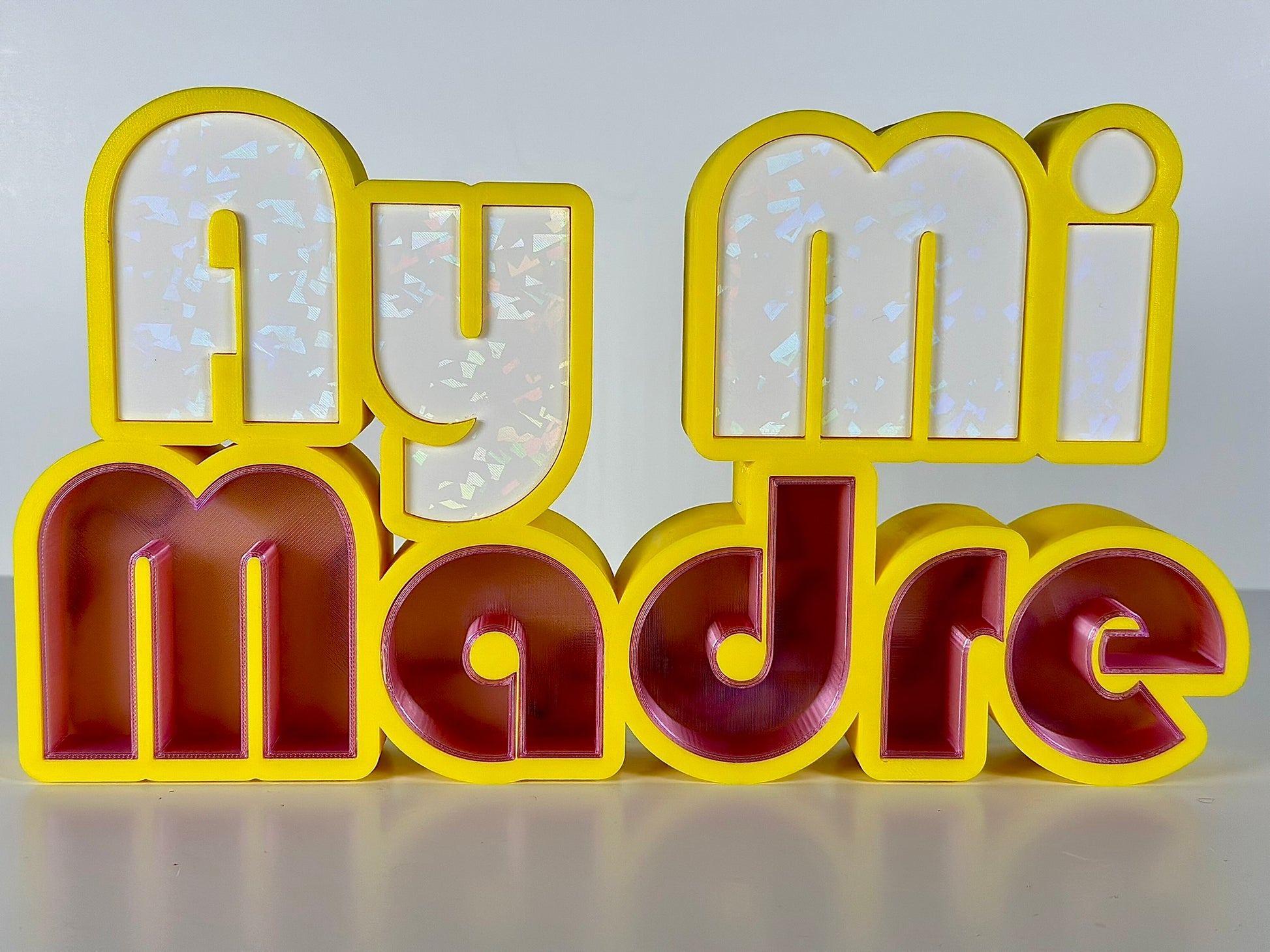 Angled side view of Ay Mi Madre LED Channel Letter Sign in yellow with red and white letters, displayed against a white background.