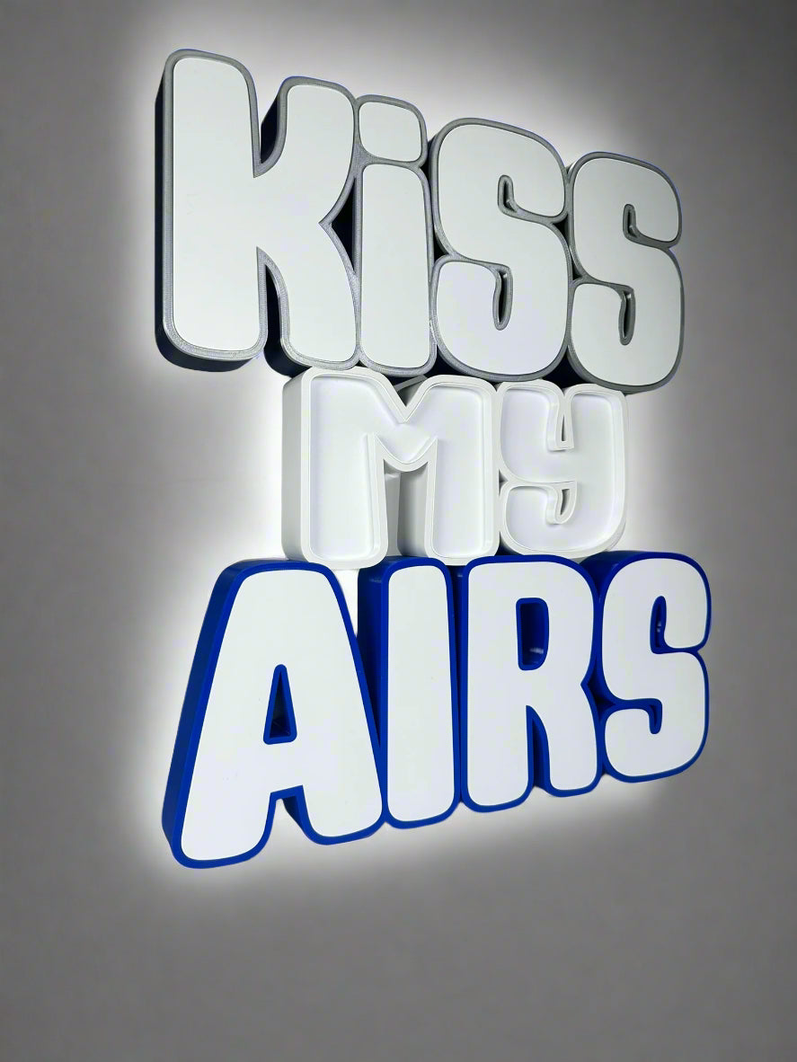 Angled side view of the Kiss My Airs LED Channel Letter Sign, highlighting the 3D construction and bold white letters, displayed against a white background.