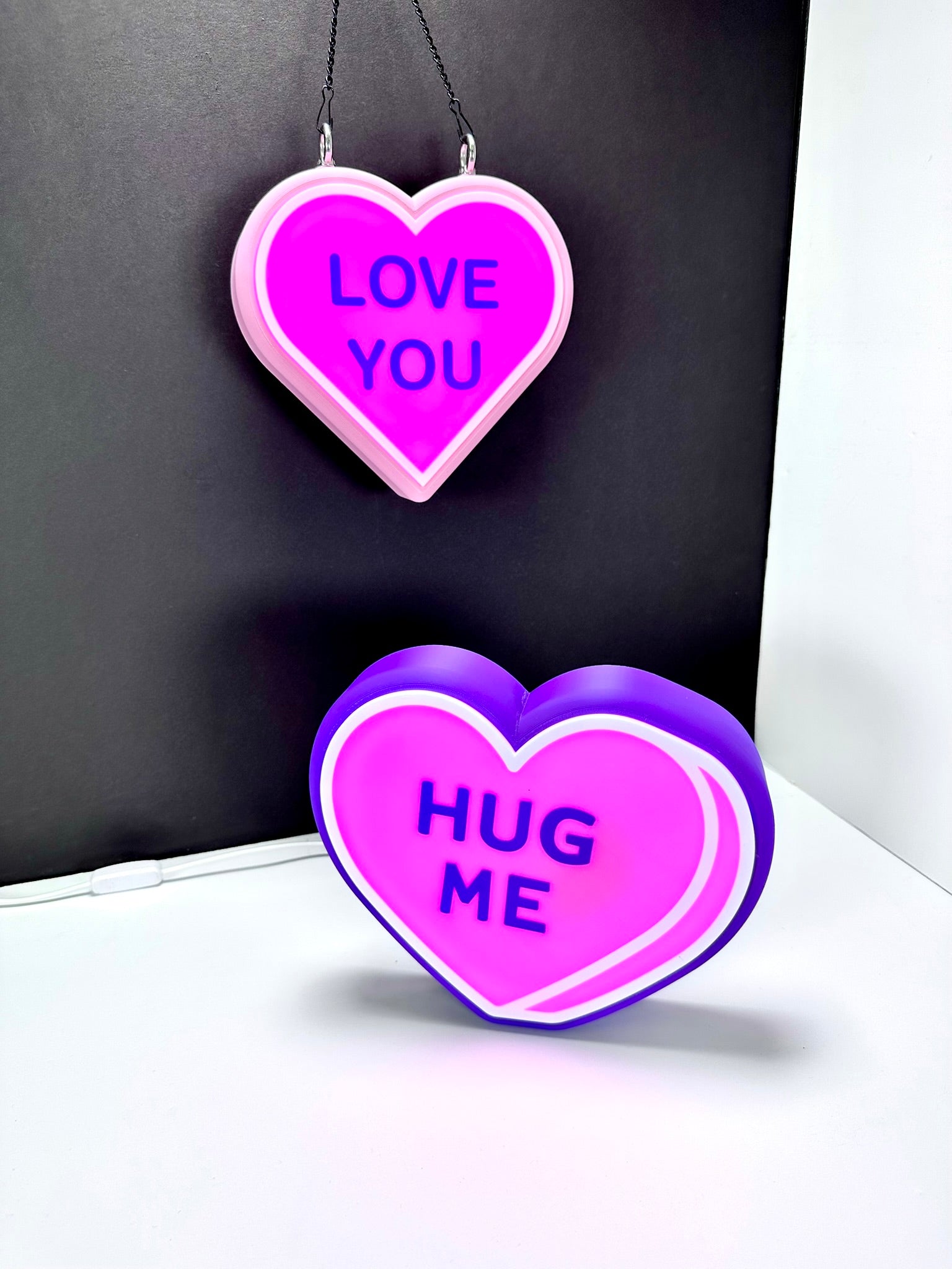 Custom LED signs: pink 'LOVE YOU' and purple 'HUG ME.' Valentine gift idea.