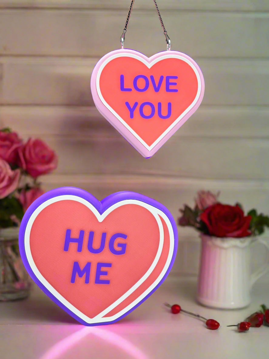 Custom LED Valentine’s signs: pink 'LOVE YOU' and purple 'HUG ME