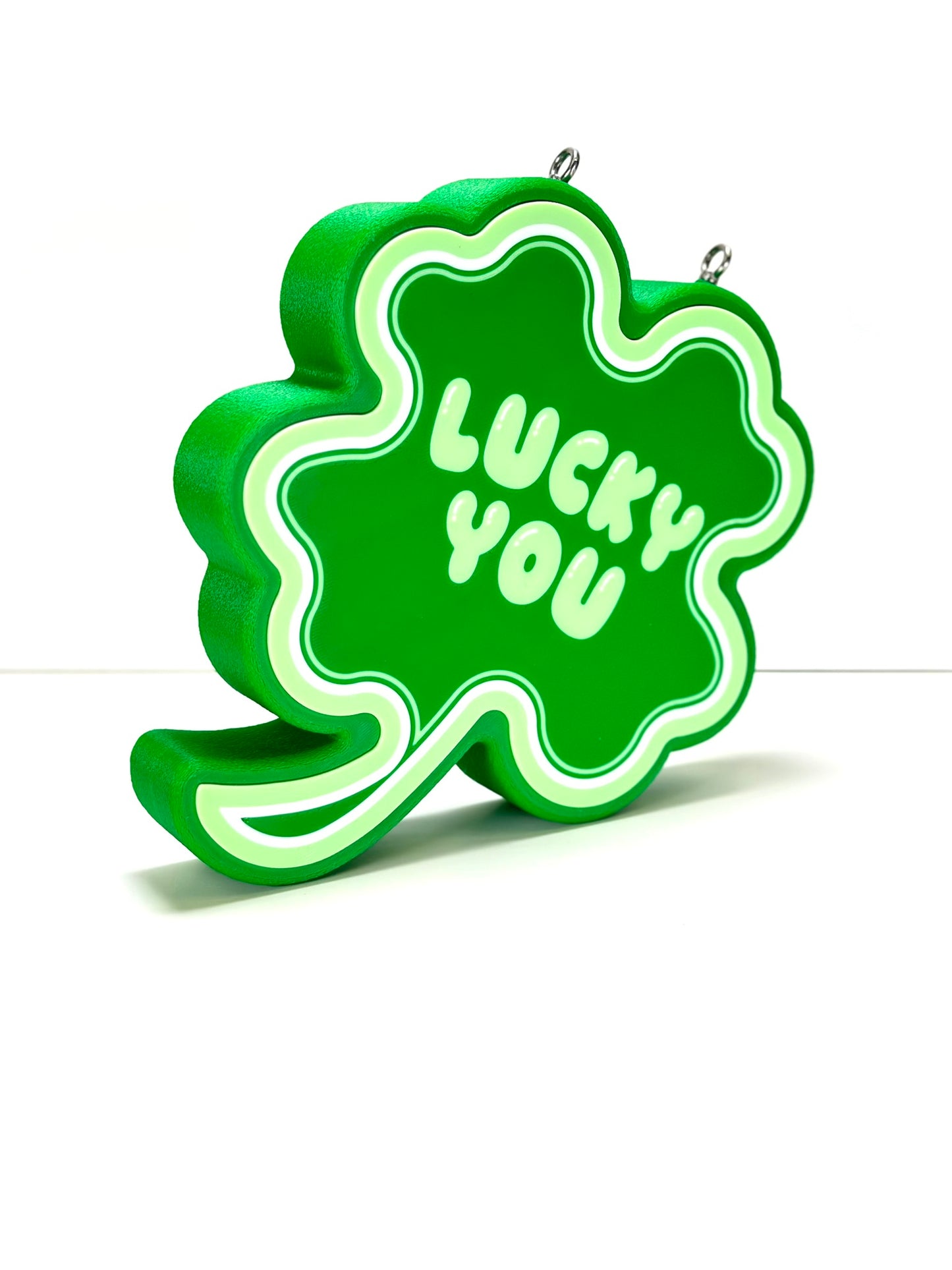 Side view of a 3D-printed Shamrock LED sign, highlighting the layered design and depth
