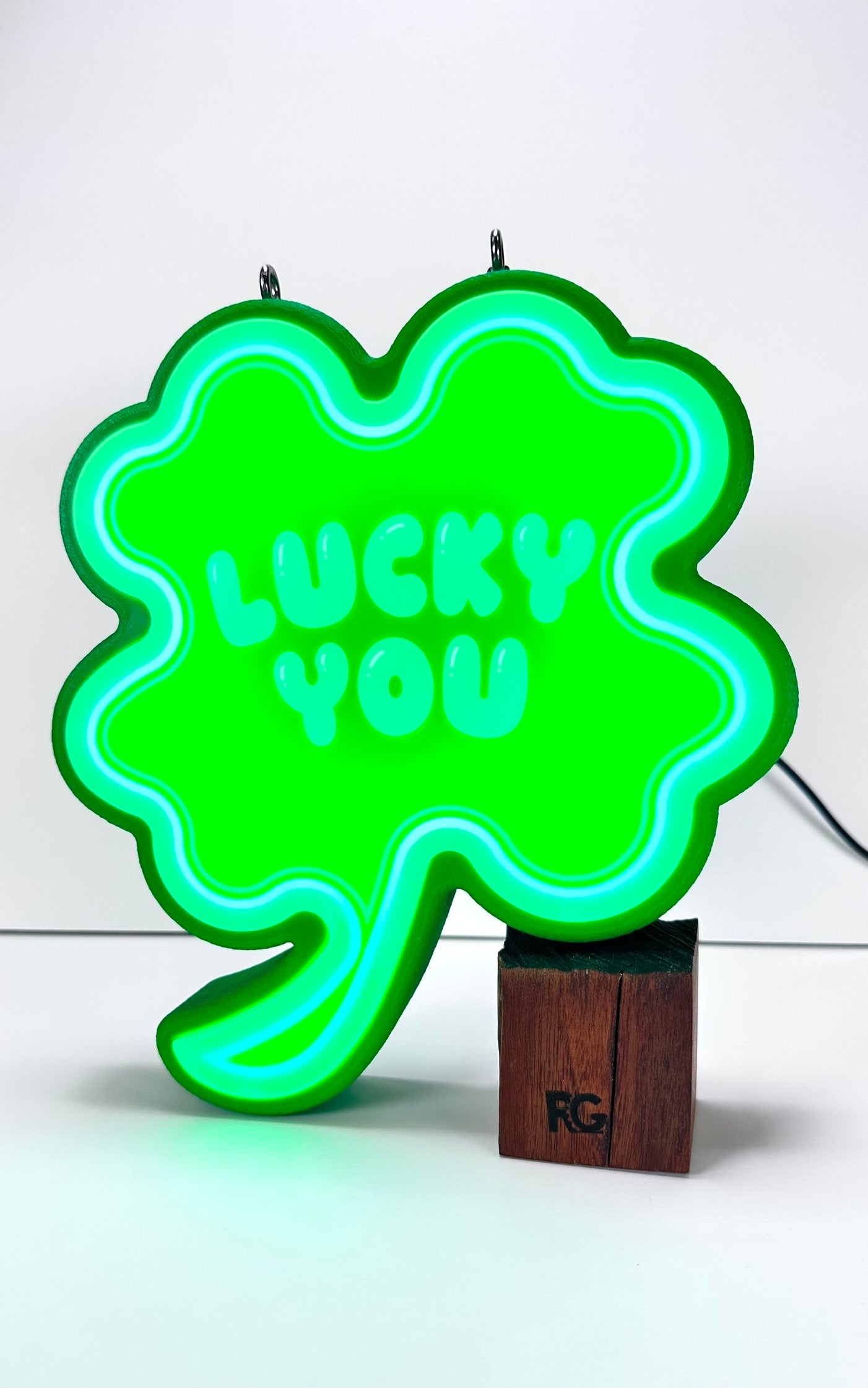 Glowing Shamrock LED sign with “Lucky You” text, illuminated in bright green light
