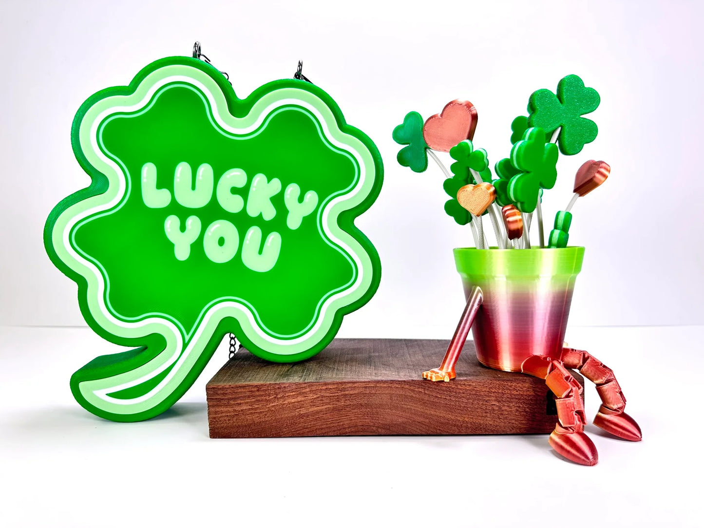 Shamrock LED sign with “Lucky You” text, glowing brightly, next to themed St. Patrick’s Day decorations