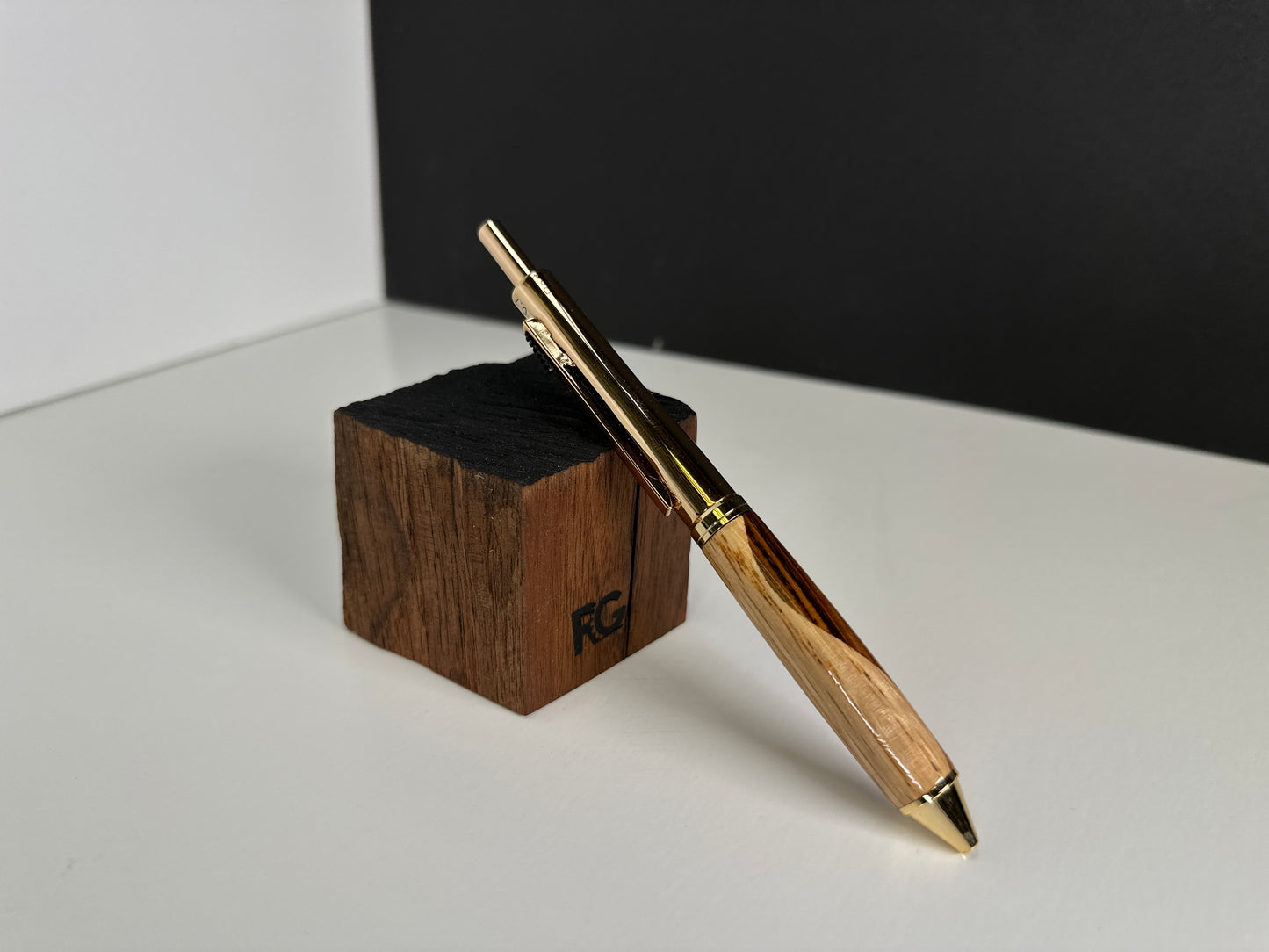 Close-up of gold-accented oak and zebrawood pen