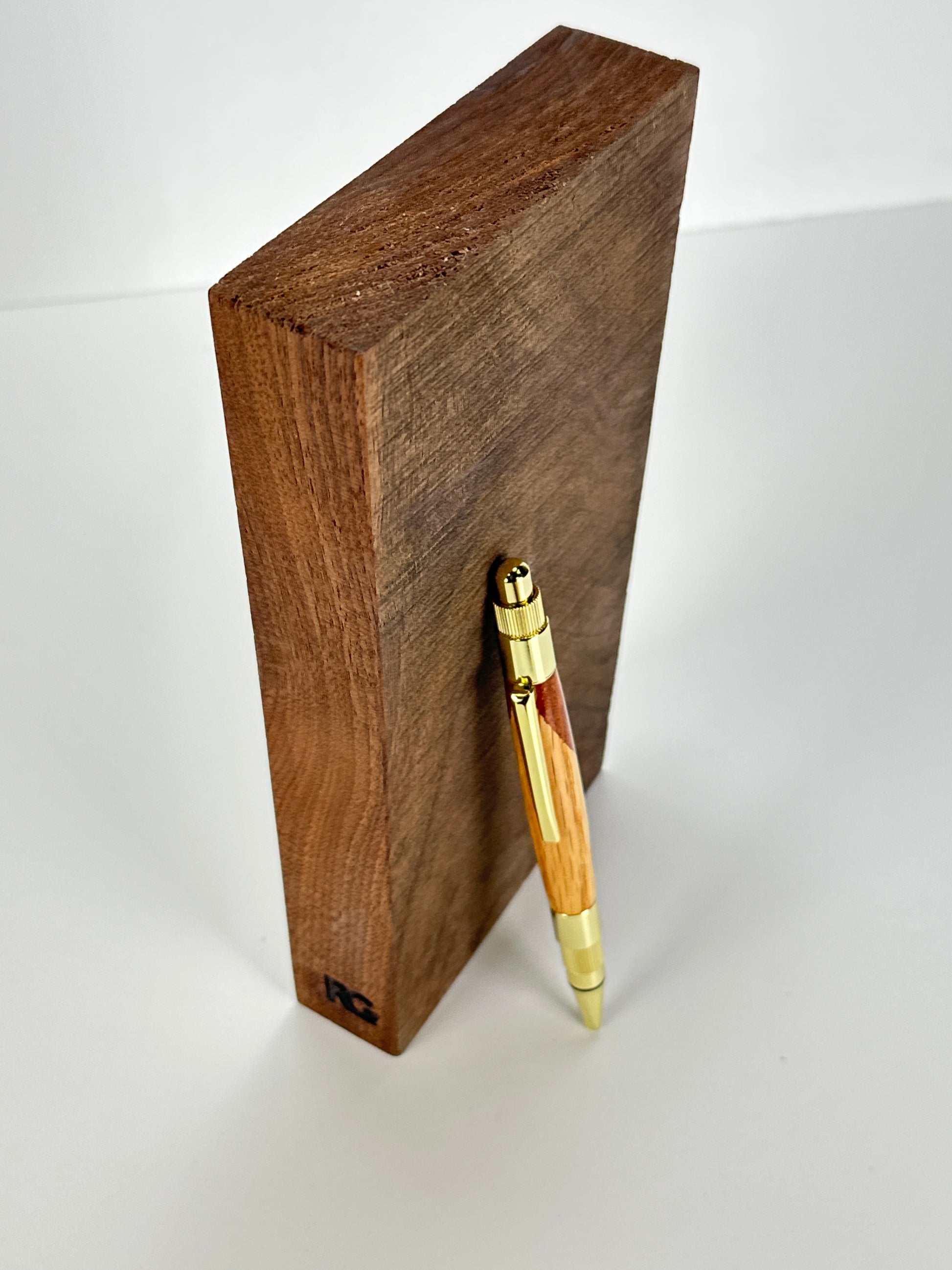 Pen leaning on a wooden block