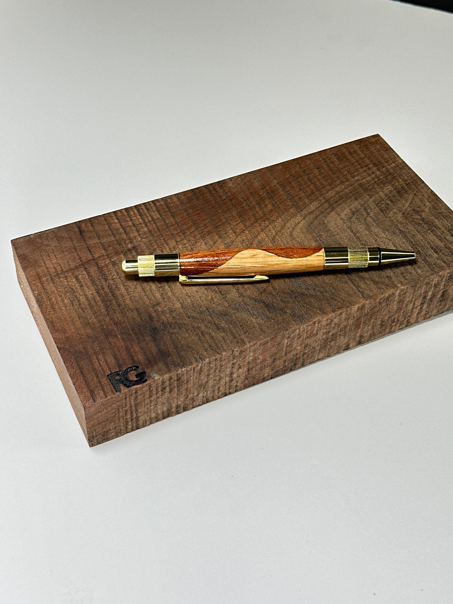 Wooden pen in focus with white background.