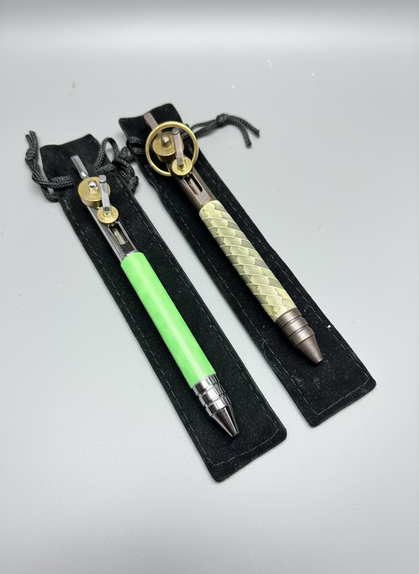 Two pens with green and silver accents on a textured surface