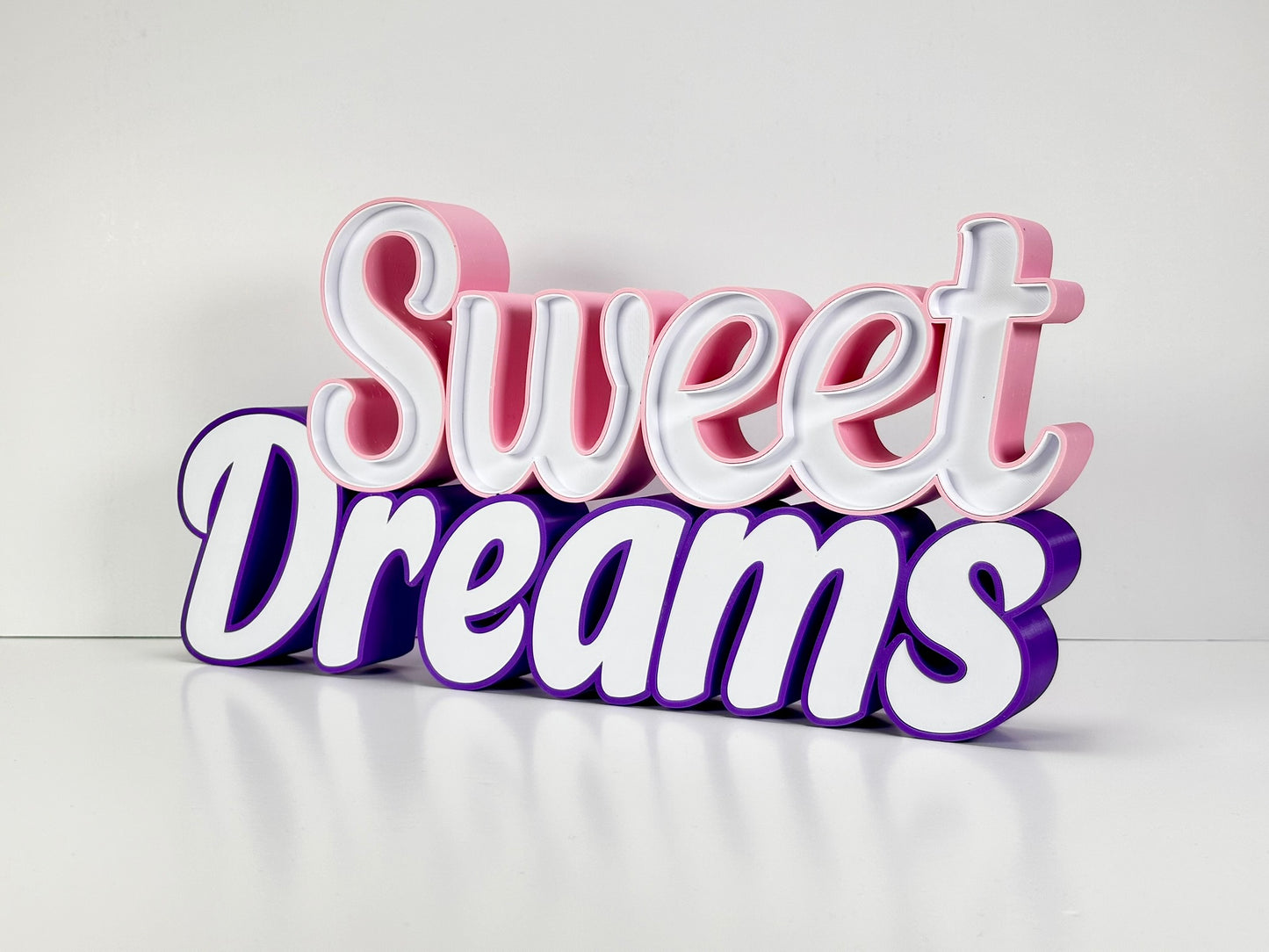 Sweet Dreams LED Channel Sign in vibrant pink and purple colors, featuring the words 'Sweet Dreams' in a stylish font, displayed against a white background. The sign is shown without illumination, highlighting its elegant and modern design, perfect for home decor