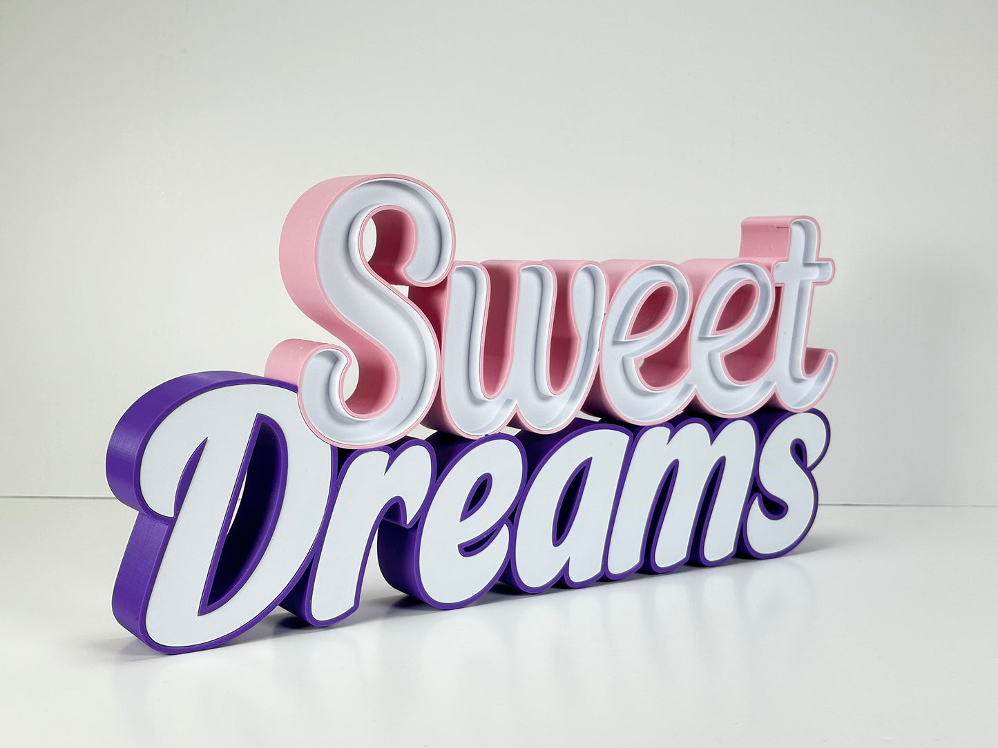 Angled side view of the Sweet Dreams LED Channel Sign, highlighting the 3D structure and vibrant pink and purple colors, perfect for adding a unique touch to home decor