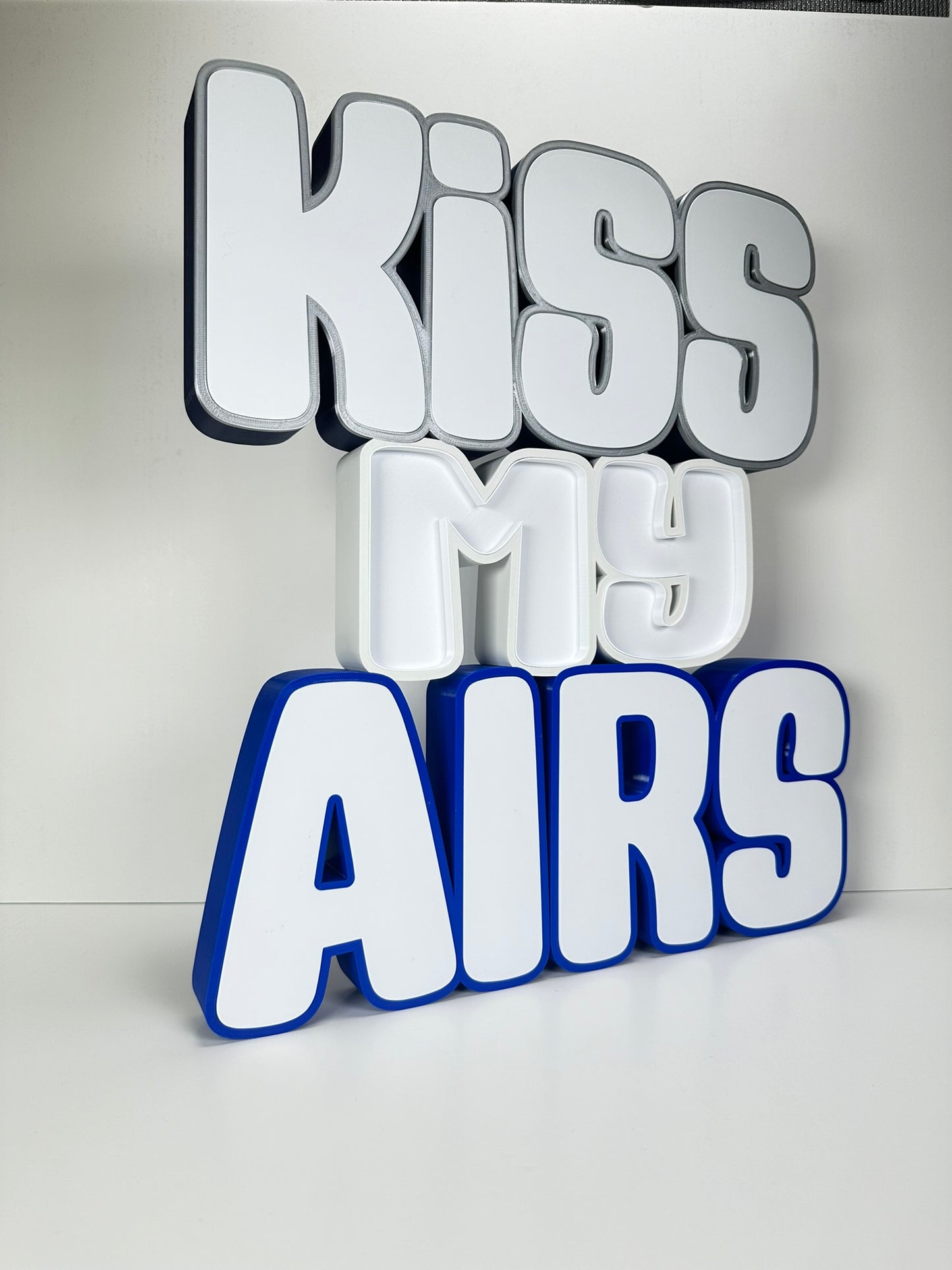 Angled side view of the Kiss My Airs LED Channel Letter Sign, highlighting the 3D construction and bold white letters, displayed against a white background.