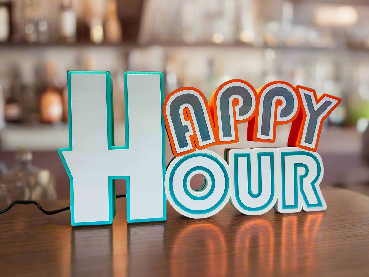 Front view of a 3D printed 'Happy Hour' sign in bold block letters with turquoise and orange accents, displayed against a white background.