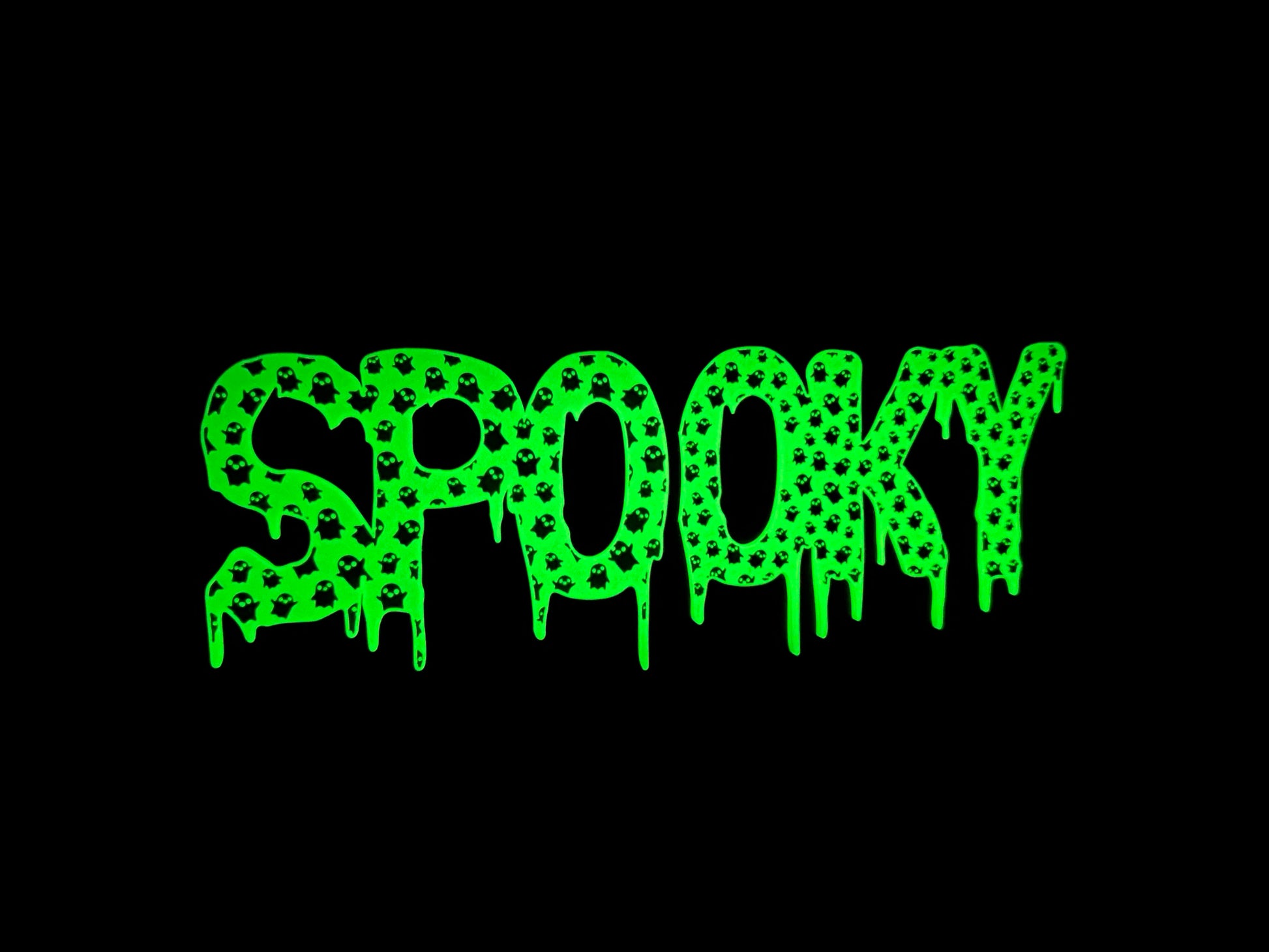 A glowing “Spooky” LED sign with a dripping design, lighting up a dark background with a vibrant green glow and mini ghost details, ideal for creating a spooky atmosphere.