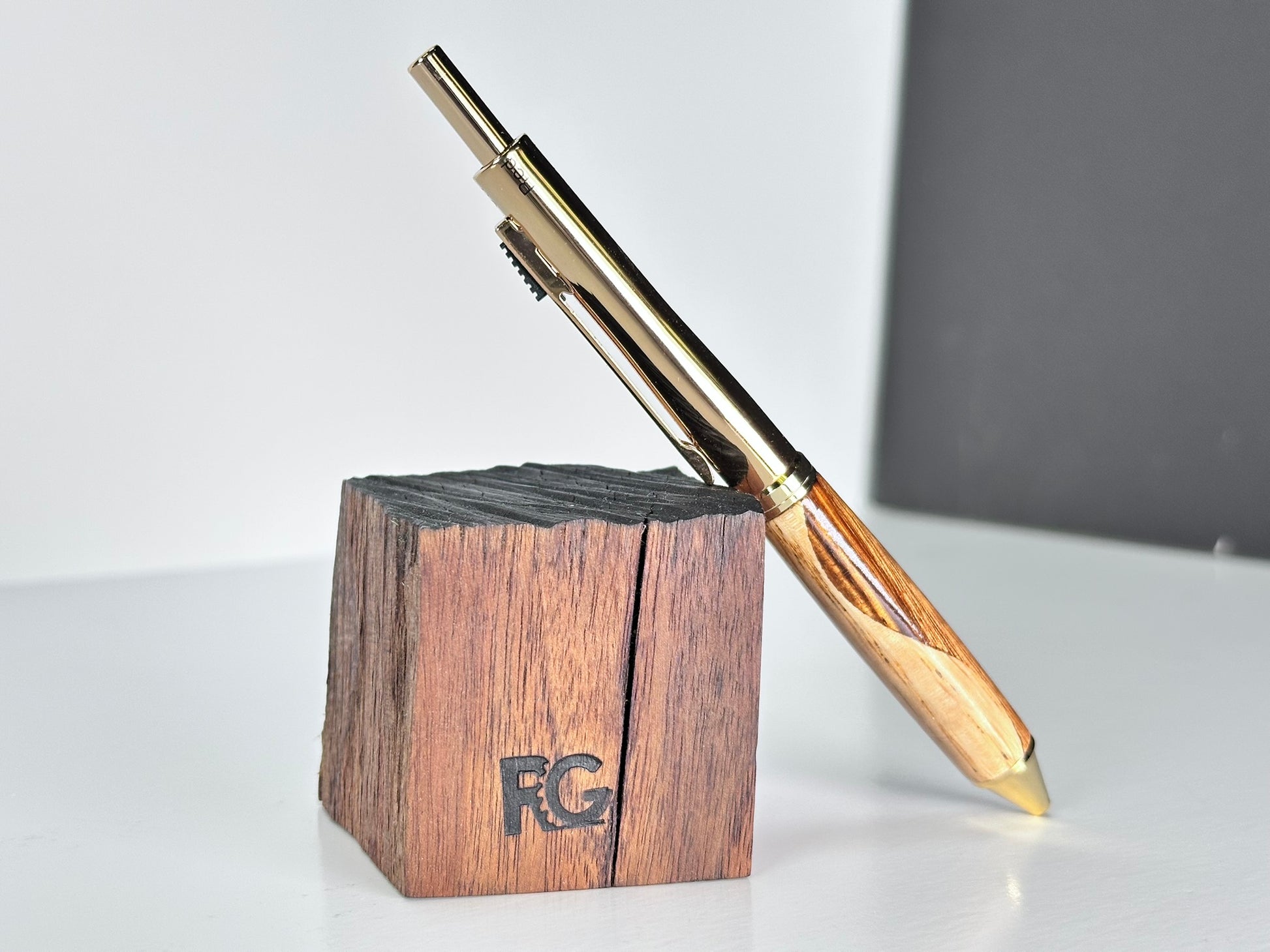 Unique oak and zebrawood pen with gold details.